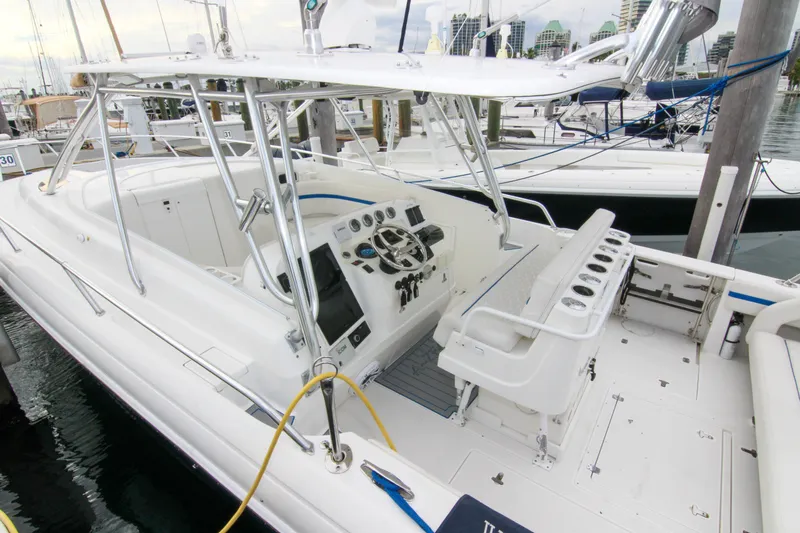  Yacht Photos Pics 2003 Intrepid 377 Walkaround boat with spacious cockpit and modern controls at a marina.