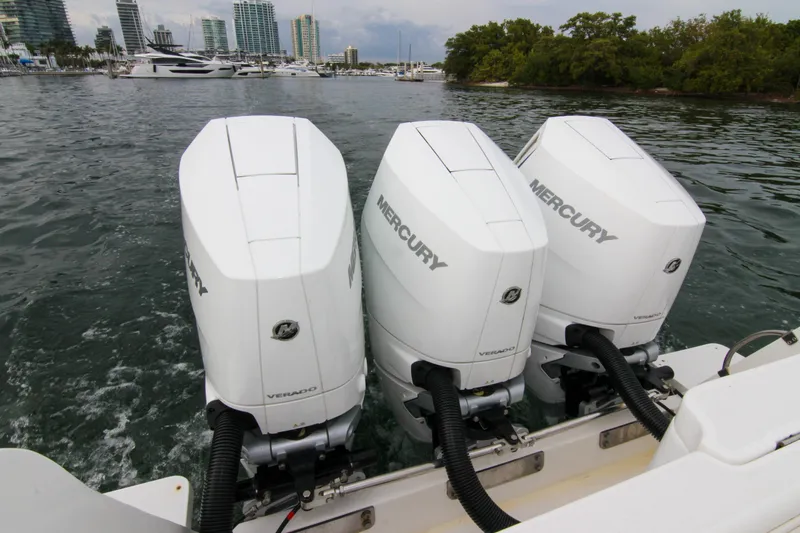  Yacht Photos Pics Triple Mercury Verado engines on a 2003 Intrepid 377 Walkaround boat in a marina.