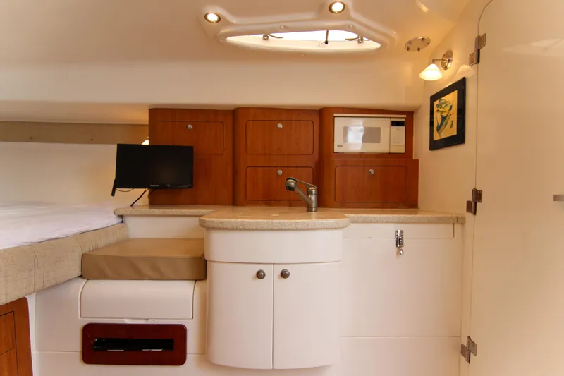  Yacht Photos Pics 2003 Intrepid 377 Walkaround cabin interior with kitchenette, sink, and microwave.