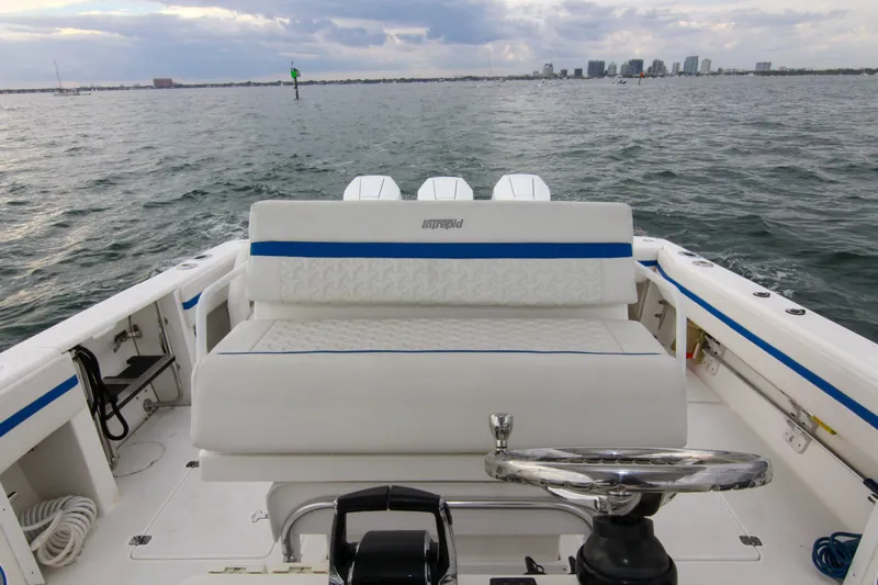  Yacht Photos Pics 2003 Intrepid 377 Walkaround boat on open water, featuring a spacious seating area.