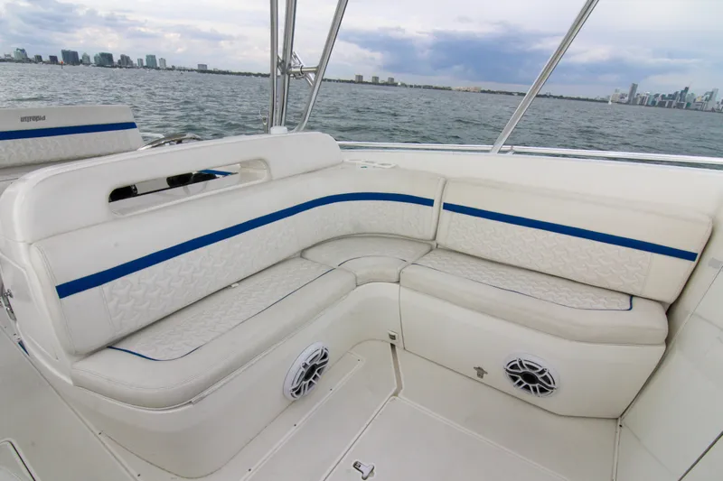  Yacht Photos Pics 2003 Intrepid 377 Walkaround boat with white seating and blue accents on open water.