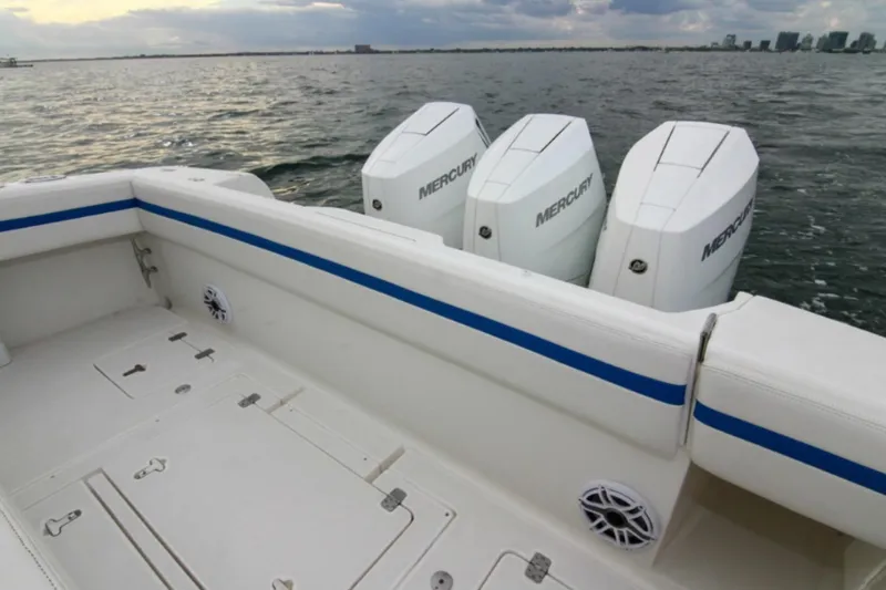  Yacht Photos Pics 2003 Intrepid 377 Walkaround boat with triple Mercury engines on open water.