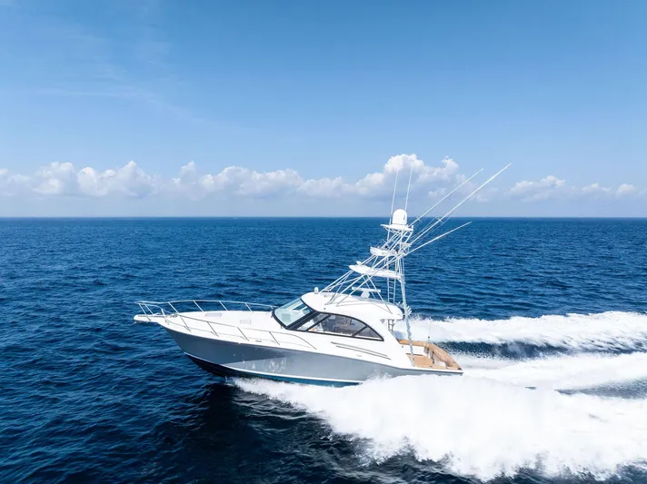 Milling Time Yacht Photos Pics 2016 Hatteras Express Sportfish cruising on open ocean under clear blue sky.