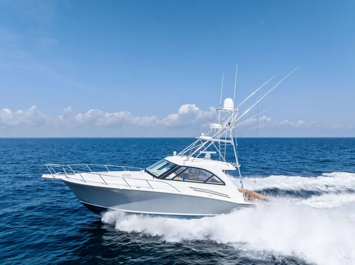 Milling Time Yacht Photos Pics 2016 Hatteras Express Sportfish cruising on open ocean under clear blue sky.