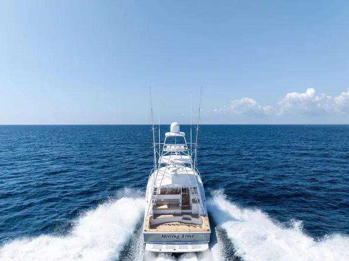 Milling Time Yacht Photos Pics 2016 Hatteras Express Sportfish cruising on open ocean under clear blue sky.
