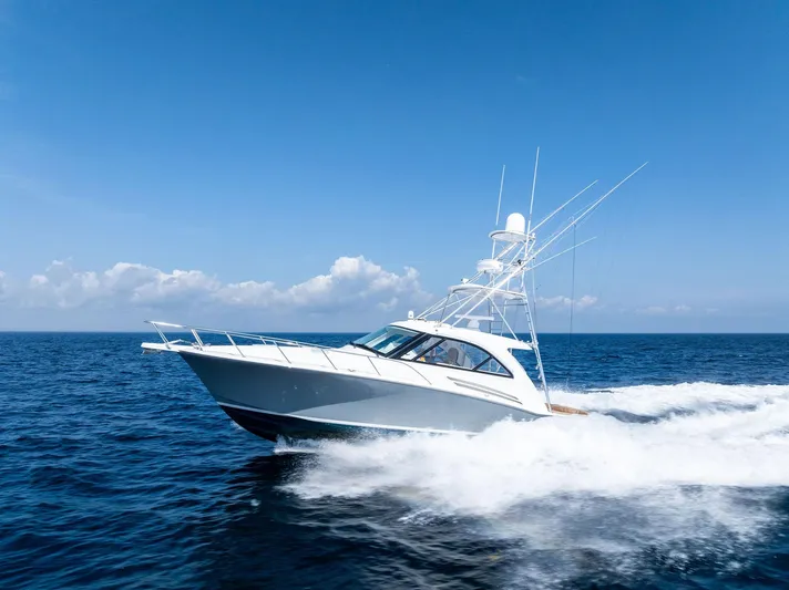 Milling Time Yacht Photos Pics 2016 Hatteras Express Sportfish yacht cruising on open ocean under clear blue sky.
