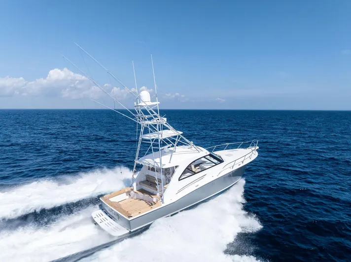 Milling Time Yacht Photos Pics 2016 Hatteras Express Sportfish yacht cruising on open ocean under clear blue sky.