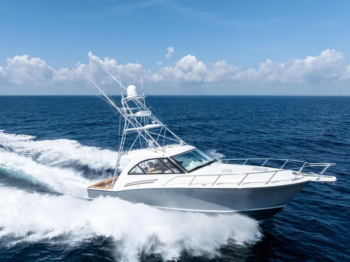 Milling Time Yacht Photos Pics 2016 Hatteras Express Sportfish cruising on open ocean under clear blue sky.