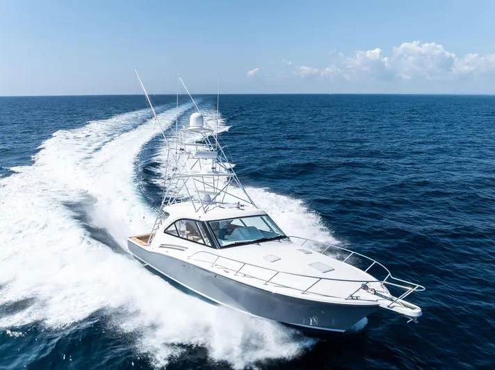 Milling Time Yacht Photos Pics 2016 Hatteras Express Sportfish yacht cruising on open ocean under clear skies.