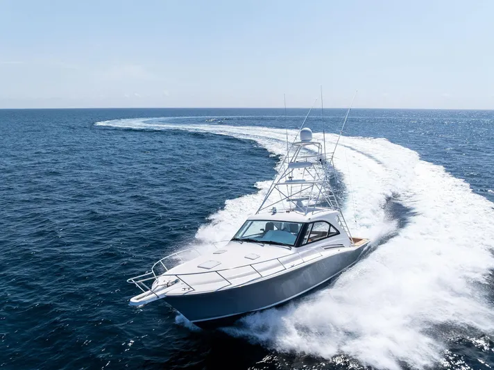 Milling Time Yacht Photos Pics 2016 Hatteras Express Sportfish cruising swiftly on open ocean waters.