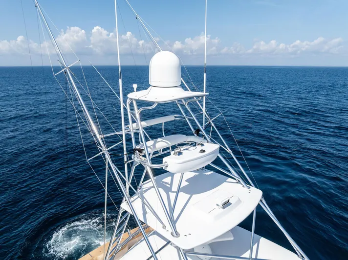 Milling Time Yacht Photos Pics 2016 Hatteras Express Sportfish yacht tower against ocean backdrop.