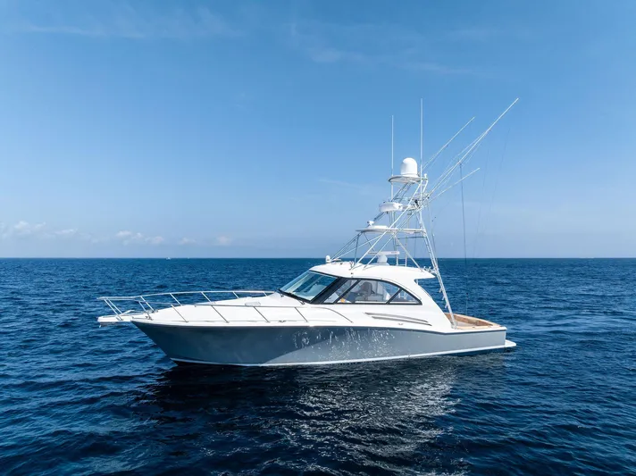 Milling Time Yacht Photos Pics 2016 Hatteras Express Sportfish yacht on open ocean under clear blue sky.