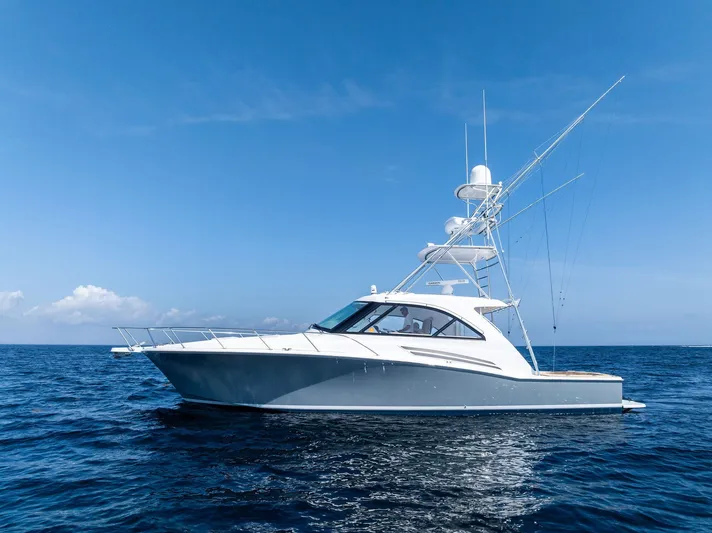 Milling Time Yacht Photos Pics 2016 Hatteras Express Sportfish yacht on open sea under clear blue sky.