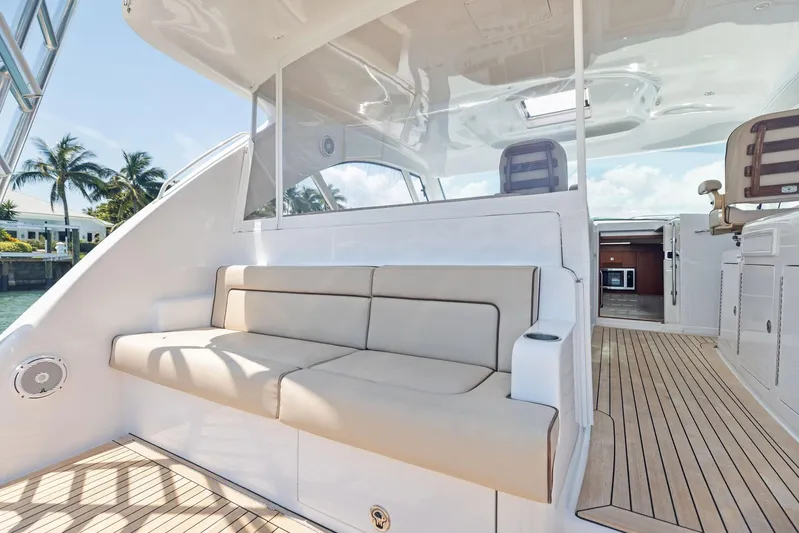 Milling Time Yacht Photos Pics 2016 Hatteras Express Sportfish yacht with spacious deck seating and modern interior.