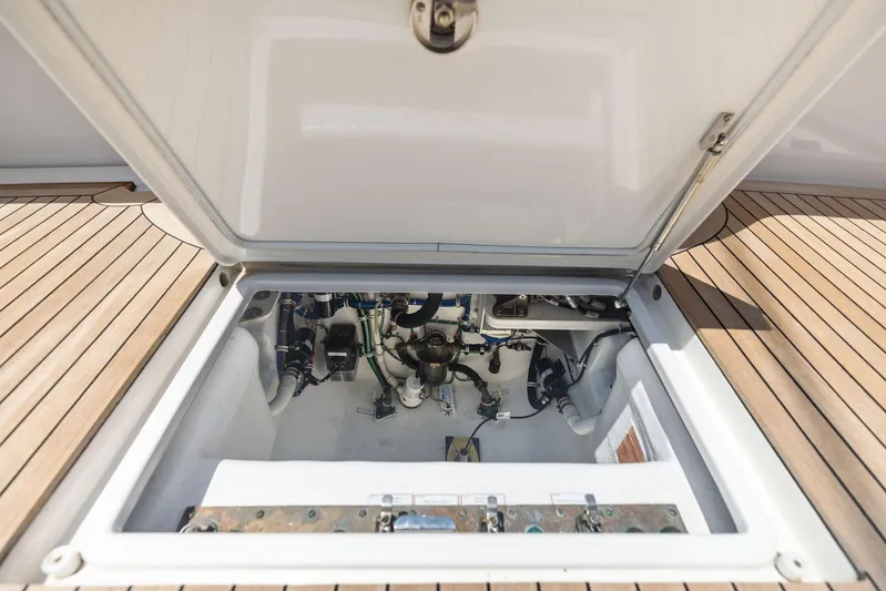 Milling Time Yacht Photos Pics Engine compartment of 2016 Hatteras Express Sportfish with open hatch on teak deck.