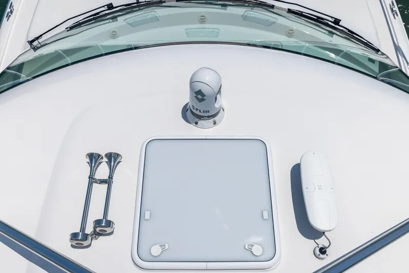 Milling Time Yacht Photos Pics 2016 Hatteras Express Sportfish boat deck with radar and hatch.