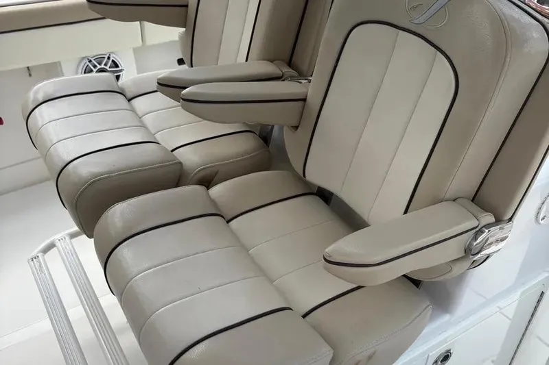  Yacht Photos Pics Luxurious seating on a 2017 Jupiter 38 FS boat, featuring beige upholstery and armrests.