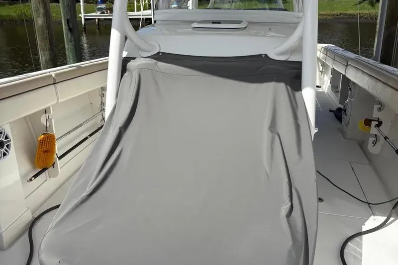 Yacht Photos Pics 2017 Jupiter 38 FS boat deck with protective cover, docked by the water.