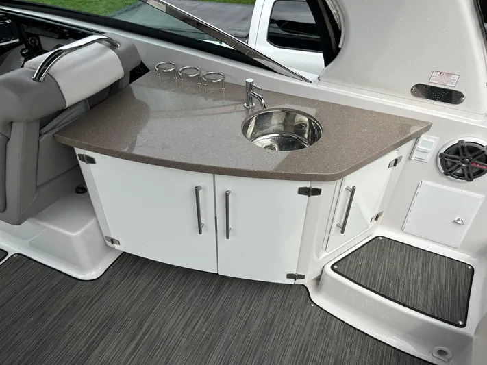  Yacht Photos Pics 2018 Four Winns Horizon H290 boat interior with sink and storage cabinets.