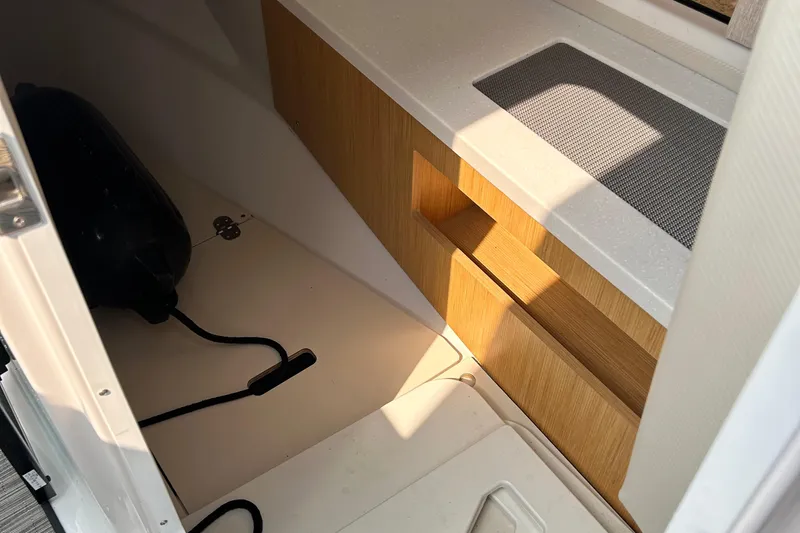  Yacht Photos Pics Interior cabin of 2018 Four Winns Horizon H290 boat, featuring wood accents and storage space.