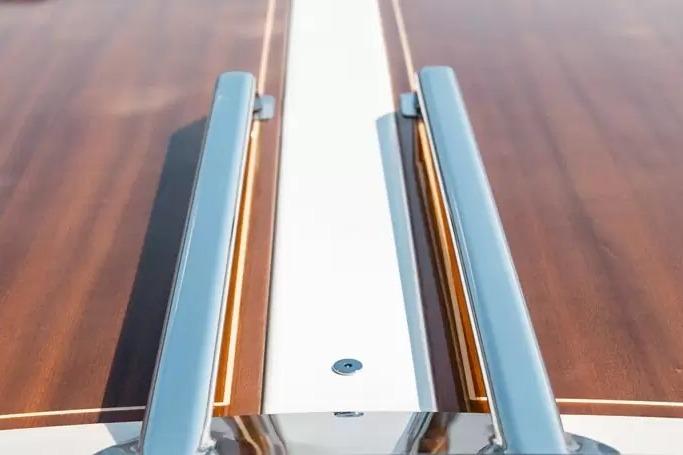 2022 Ecoline Marine Ecolux 850 boat deck with sleek wood and metal design.