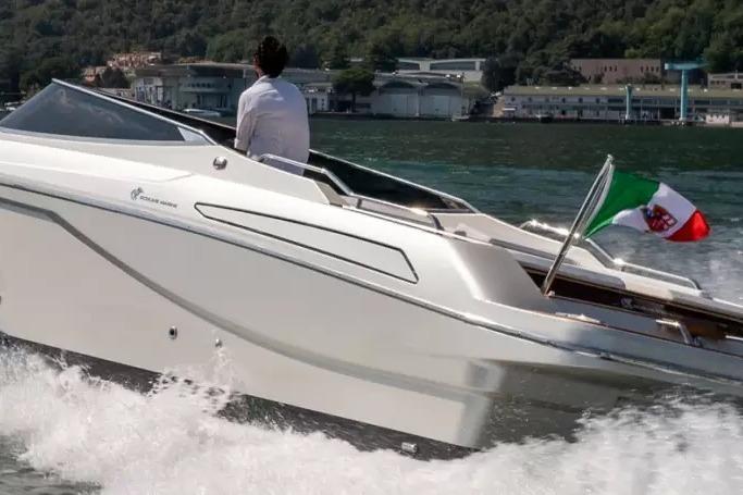 2022 Ecoline Marine Ecolux 850 boat cruising on water with Italian flag.