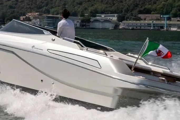 2022 Ecoline Marine Ecolux 850 boat cruising on water with Italian flag.