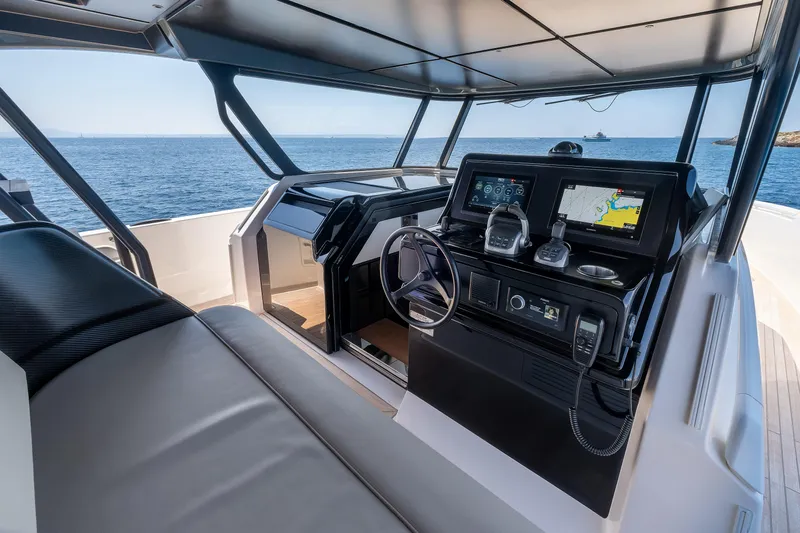  Yacht Photos Pics 2024 Bluegame 54 yacht cockpit with modern navigation systems and ocean view.