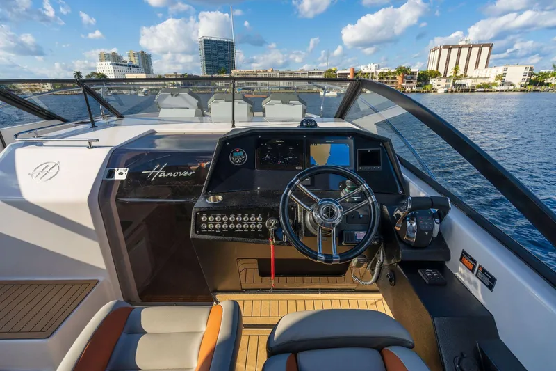Custom Order Yours Today! Yacht Photos Pics 2025 Hanover 377 Outboard boat cockpit with modern controls and waterfront city view.