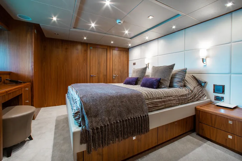 Marin Yacht Photos Pics Luxurious bedroom on a 2014 Sunseeker 131 yacht with modern wood paneling.