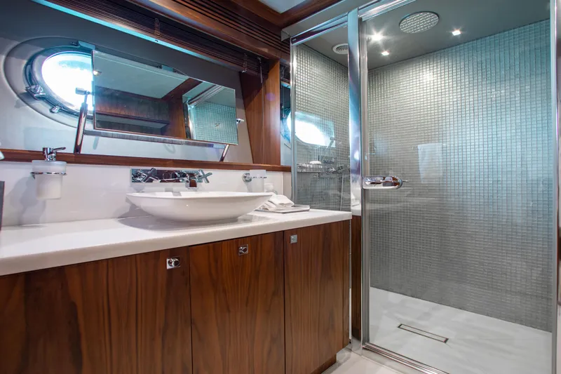 Marin Yacht Photos Pics Luxurious bathroom on 2014 Sunseeker 131 yacht with modern shower and elegant wood cabinetry.