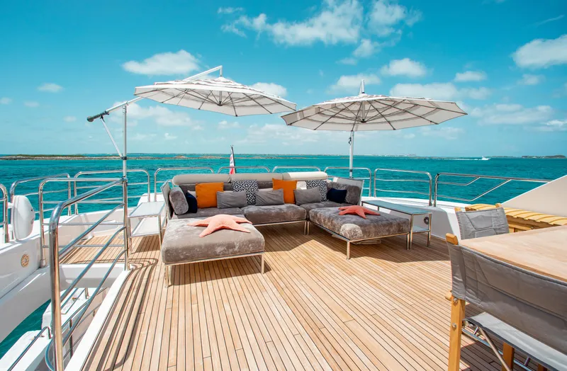 Marin Yacht Photos Pics Sunseeker 131 yacht 2014 deck with lounge chairs, umbrellas, and ocean view.