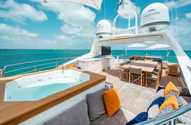 Marin Yacht Photos Pics Luxurious Sunseeker 131 yacht deck with hot tub, dining area, and ocean view.