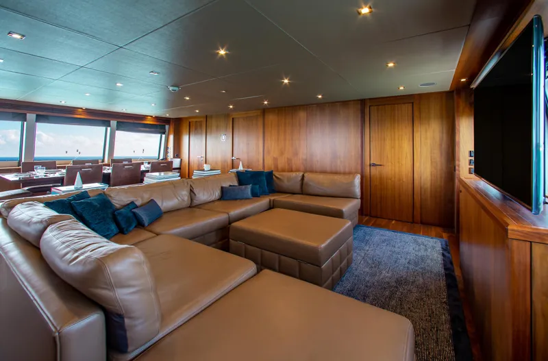 Marin Yacht Photos Pics Luxurious interior of 2014 Sunseeker 131 yacht with leather seating and wooden paneling.