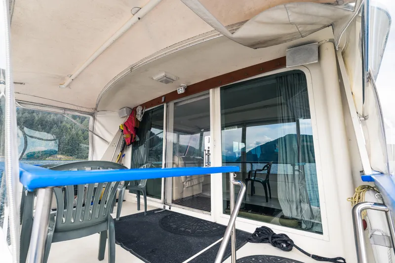  Yacht Photos Pics 1983 Hatteras Pleasure Craft deck with chairs and scenic water view.