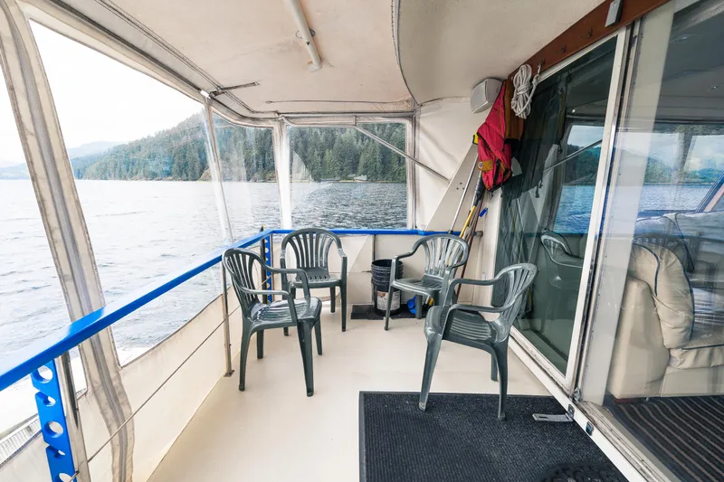  Yacht Photos Pics 1983 Hatteras Pleasure Craft deck with chairs, life jackets, and scenic lake view.