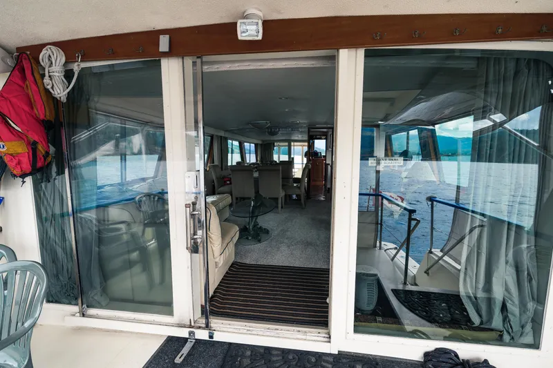  Yacht Photos Pics Interior view of a 1983 Hatteras Pleasure Craft with sliding glass doors and lake scenery.