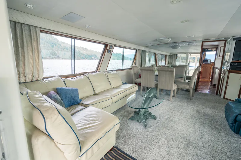  Yacht Photos Pics Luxurious interior of a 1983 Hatteras Pleasure Craft with spacious seating and dining area.