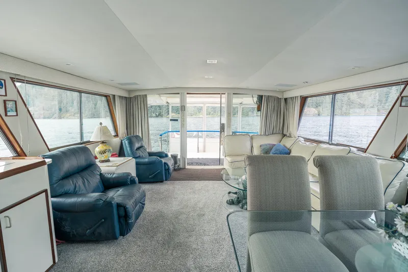  Yacht Photos Pics Interior of 1983 Hatteras Pleasure Craft with comfortable seating and large windows.