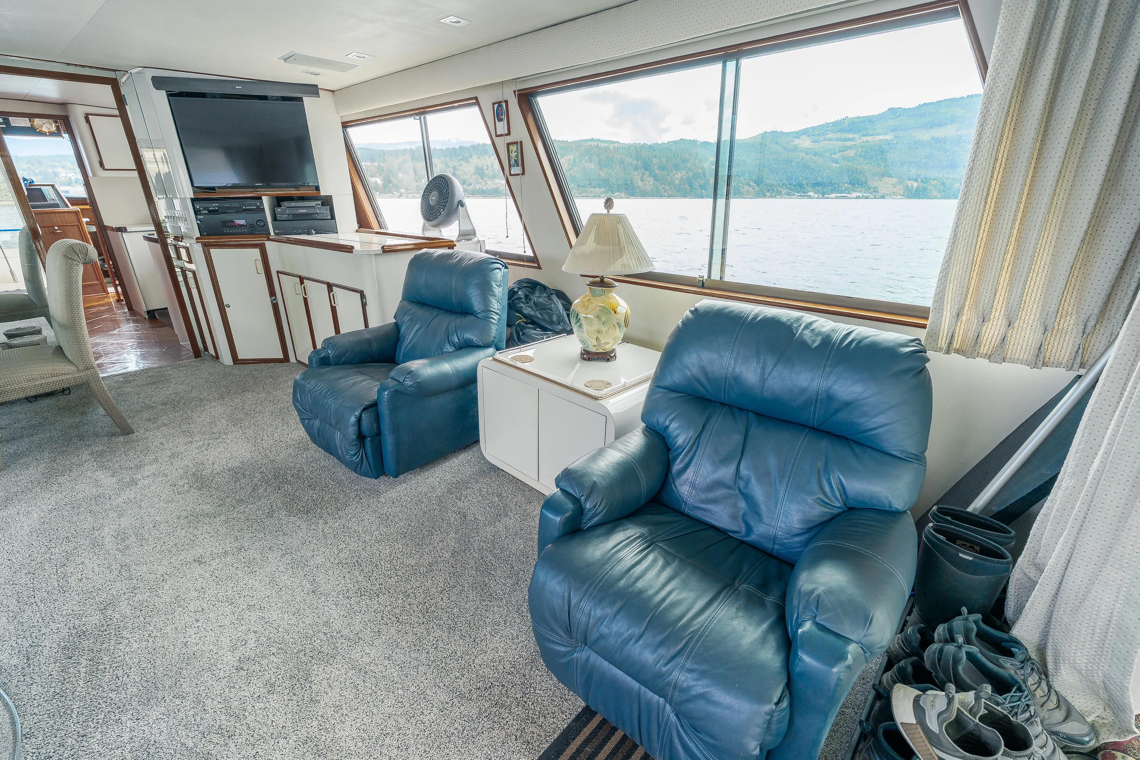  Yacht Photos Pics Interior of 1983 Hatteras Pleasure Craft with blue recliners and scenic window view.