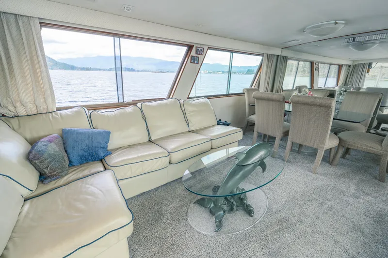  Yacht Photos Pics Luxurious 1983 Hatteras Pleasure Craft interior with elegant seating and scenic water views.