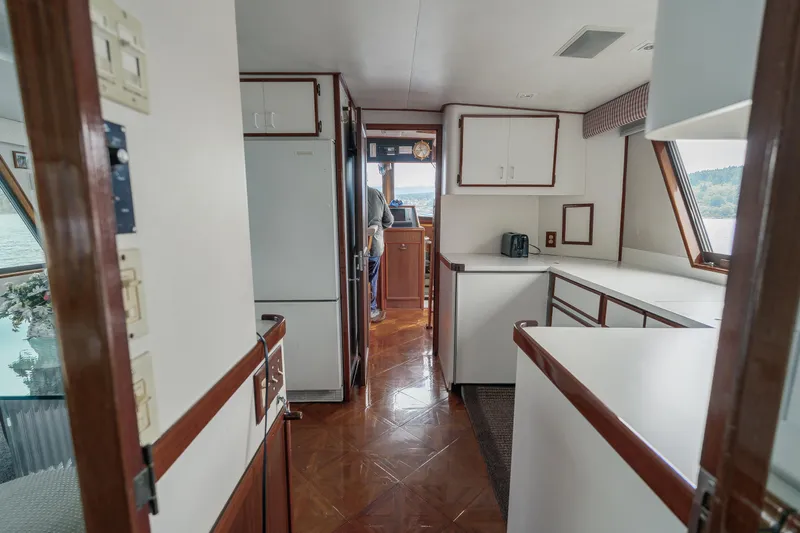  Yacht Photos Pics Interior of 1983 Hatteras Pleasure Craft with wood accents and spacious kitchen area.