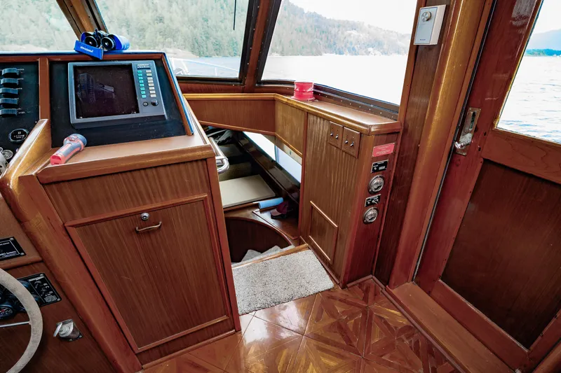  Yacht Photos Pics 1983 Hatteras Pleasure Craft interior with wooden paneling and navigation equipment.