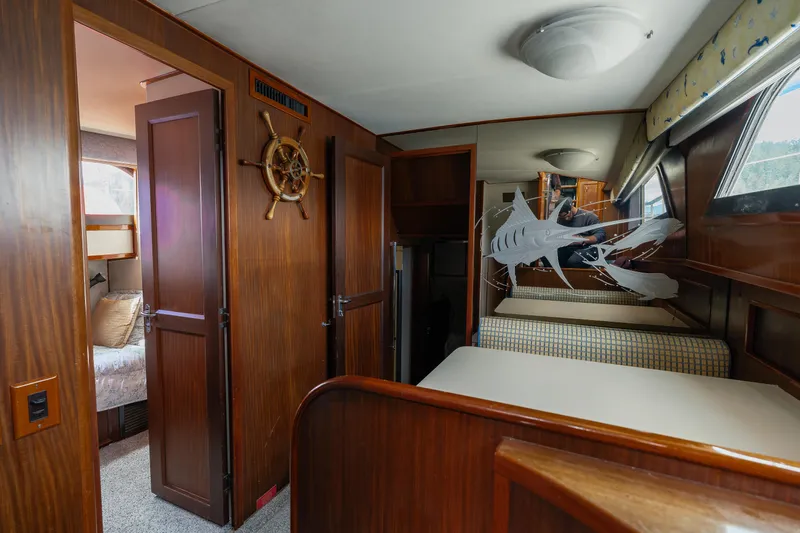  Yacht Photos Pics Interior of 1983 Hatteras Pleasure Craft with wooden paneling and nautical decor.