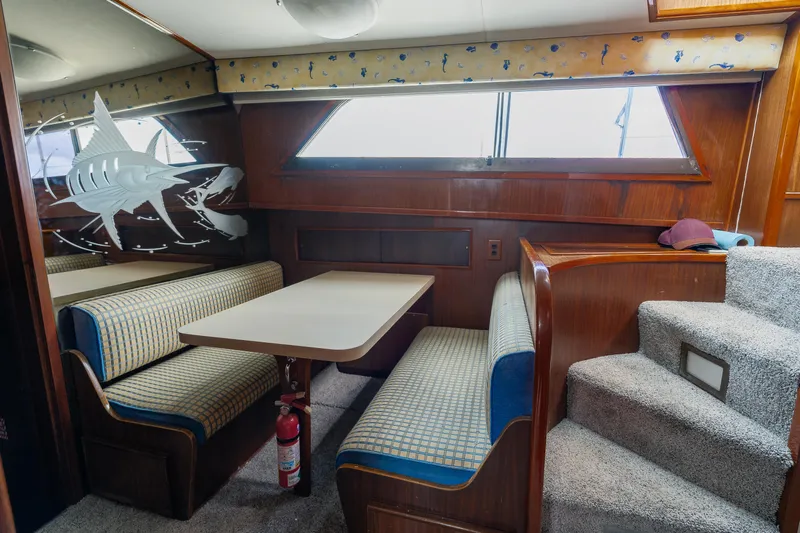 Yacht Photos Pics Interior of 1983 Hatteras Pleasure Craft with dining area and marlin wall art.