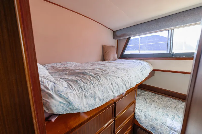  Yacht Photos Pics Interior of 1983 Hatteras Pleasure Craft with cozy bunk beds and wooden cabinetry.