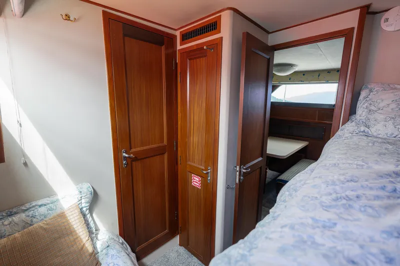  Yacht Photos Pics Interior of 1983 Hatteras Pleasure Craft with wooden doors and cozy seating area.