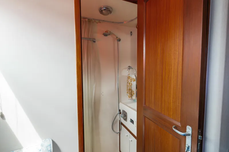  Yacht Photos Pics 1983 Hatteras Pleasure Craft bathroom with shower and wooden door.