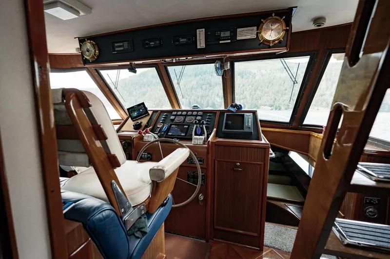  Yacht Photos Pics Interior of 1983 Hatteras Pleasure Craft cockpit with navigation equipment and captain's chair.