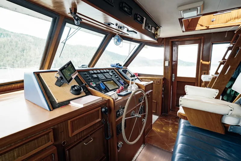  Yacht Photos Pics Interior of 1983 Hatteras Pleasure Craft with wooden helm and navigation equipment.